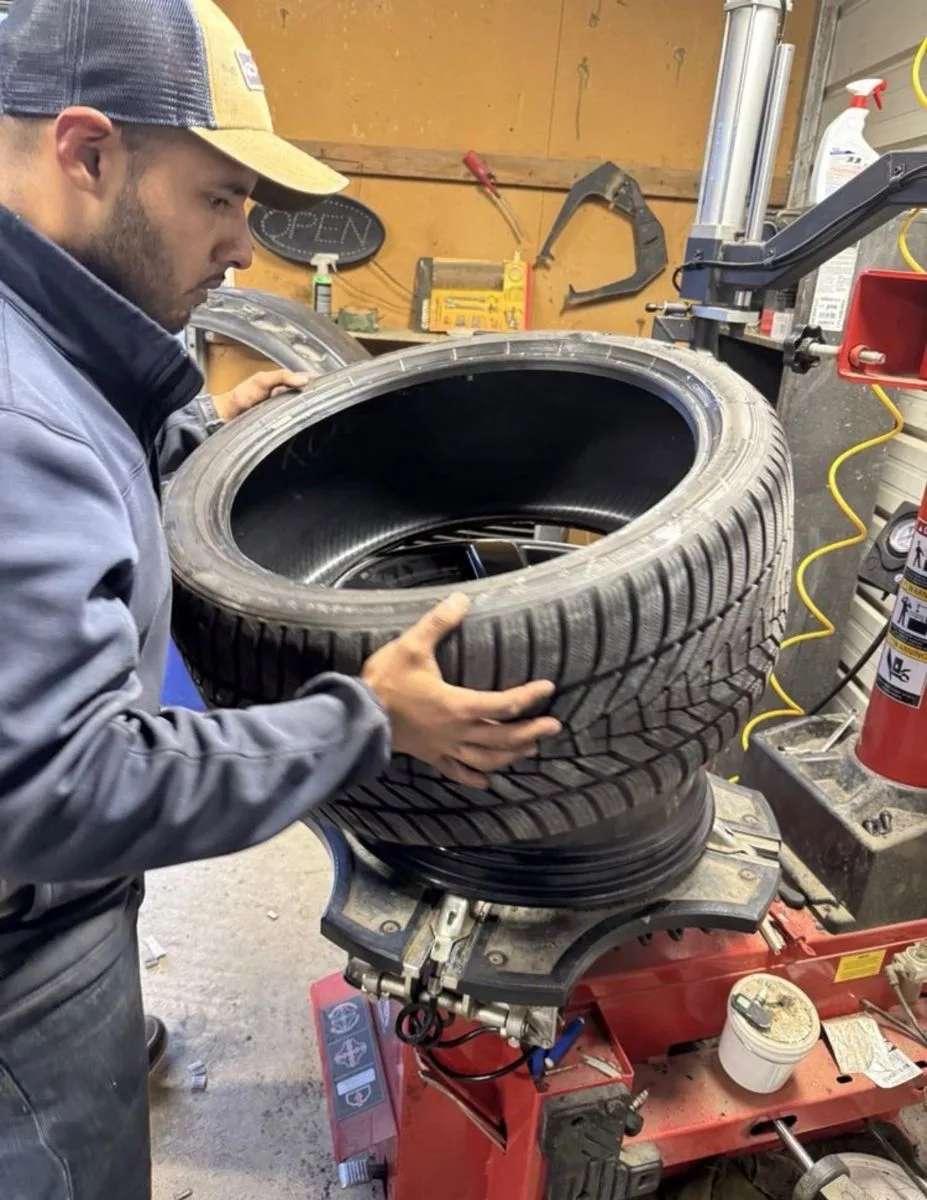Tire being mounted on a tire changer in the shop